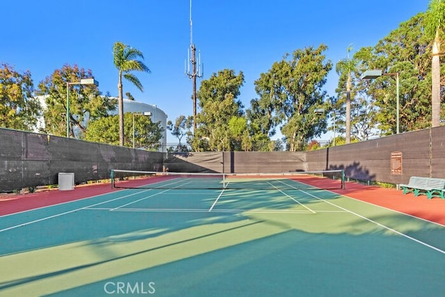 view of tennis court featuring basketball court