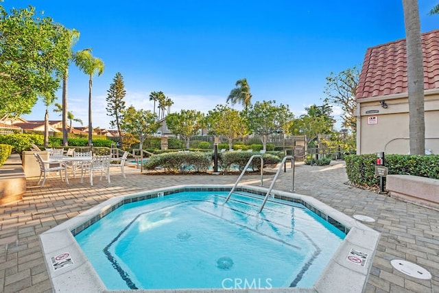 view of pool with a community hot tub and a patio