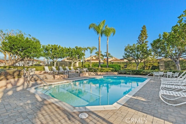 view of swimming pool with a patio