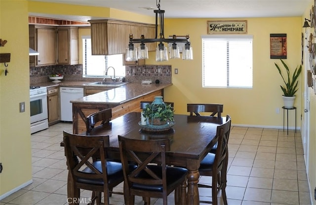 tiled dining space featuring sink