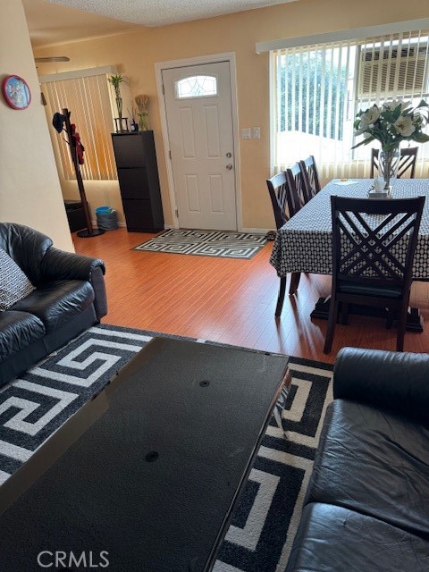 living room featuring a textured ceiling and hardwood / wood-style floors