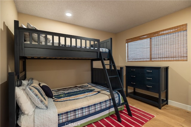 bedroom with hardwood / wood-style flooring and a textured ceiling