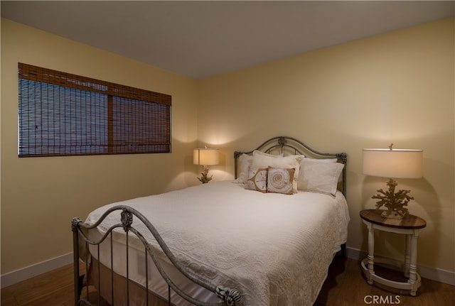 bedroom featuring dark hardwood / wood-style flooring