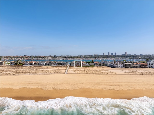 view of yard with a beach view and a water view