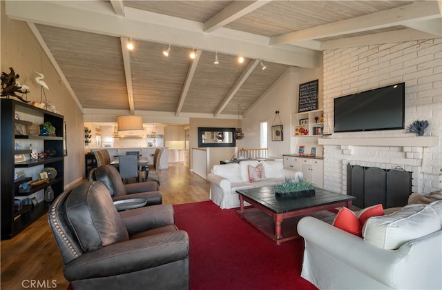 living room with wood-type flooring, vaulted ceiling with beams, a fireplace, and wooden ceiling