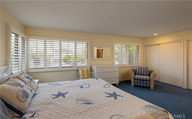 carpeted bedroom featuring a closet and multiple windows