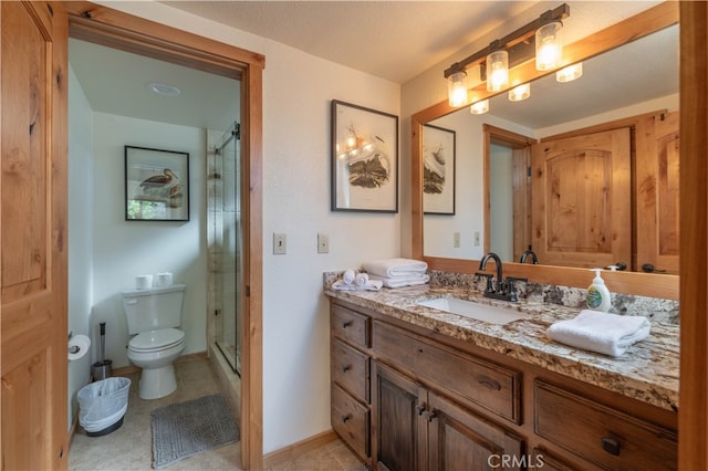 bathroom featuring a textured ceiling, a shower with door, tile patterned floors, vanity, and toilet