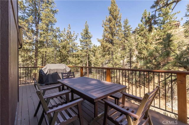 wooden terrace featuring area for grilling