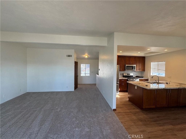 kitchen with recessed lighting, visible vents, appliances with stainless steel finishes, open floor plan, and a sink