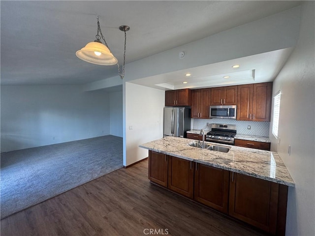 kitchen featuring appliances with stainless steel finishes, dark wood finished floors, a sink, and light stone countertops