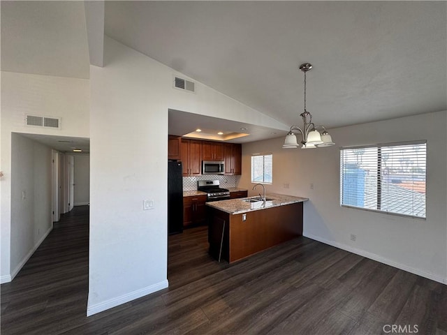 kitchen featuring a peninsula, appliances with stainless steel finishes, visible vents, and a sink