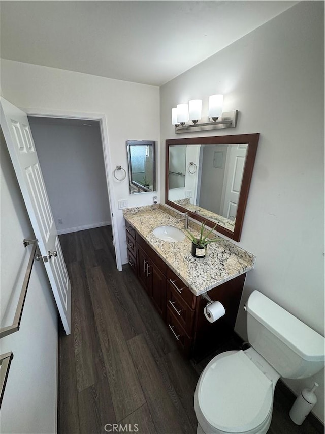 bathroom with vanity, wood finished floors, and toilet