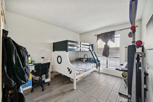 bedroom with wood-type flooring and a textured ceiling