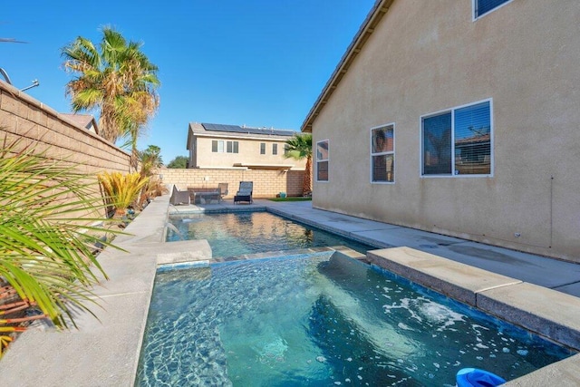 view of pool with an in ground hot tub