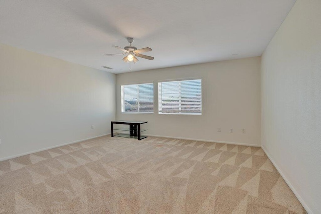 unfurnished room featuring ceiling fan and light colored carpet