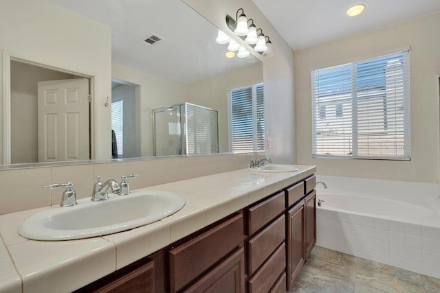 bathroom featuring vanity and shower with separate bathtub