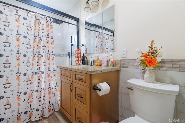 bathroom with wood-type flooring, toilet, vanity, and walk in shower