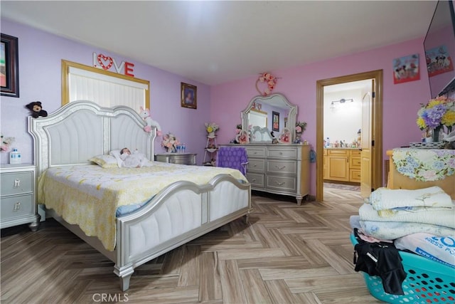 bedroom with ensuite bathroom and parquet floors