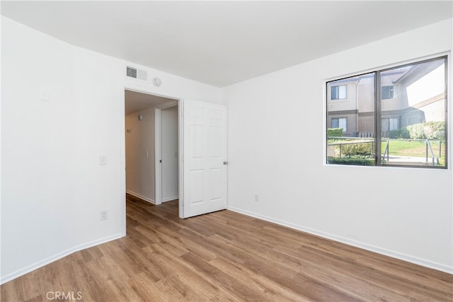 spare room featuring light hardwood / wood-style flooring