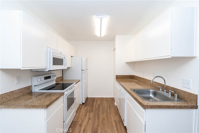 kitchen with light hardwood / wood-style flooring, sink, white appliances, and white cabinetry