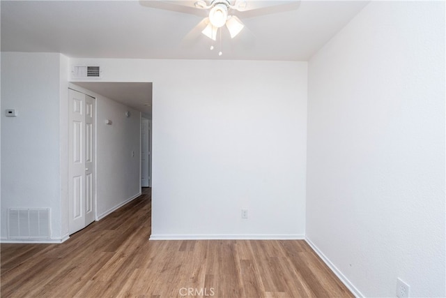 empty room featuring ceiling fan and hardwood / wood-style floors