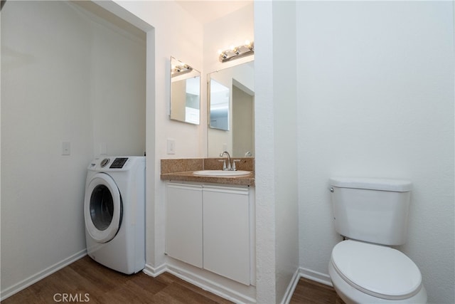 bathroom featuring vanity, washer / dryer, hardwood / wood-style floors, and toilet