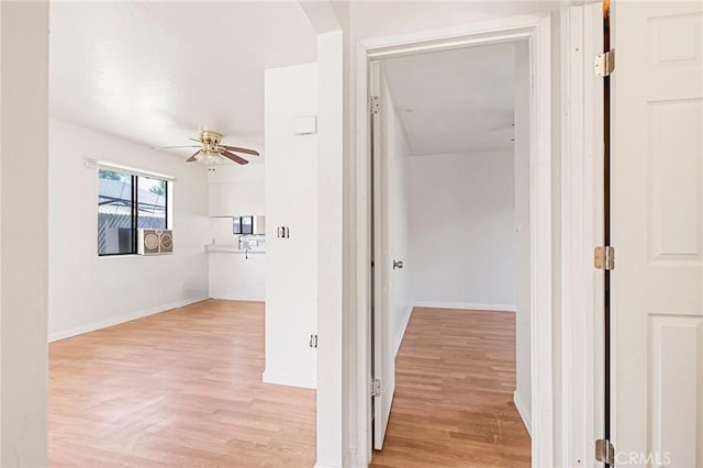 corridor with light hardwood / wood-style flooring