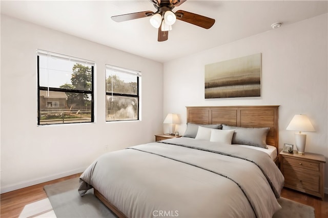 bedroom with ceiling fan and light hardwood / wood-style flooring