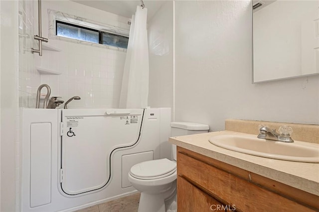 bathroom with tile patterned floors, vanity, and toilet