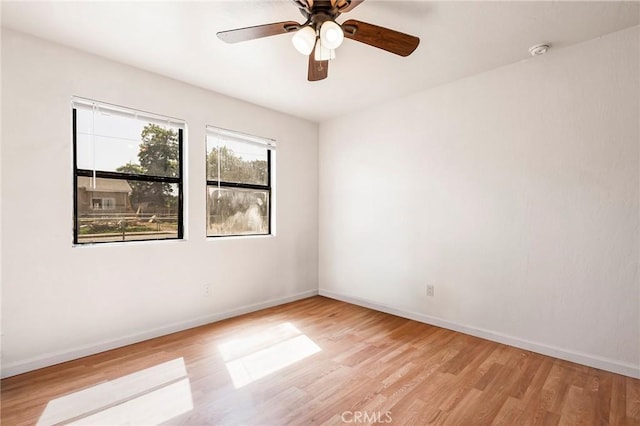 spare room with ceiling fan and light wood-type flooring