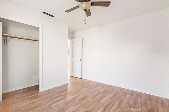 unfurnished bedroom with ceiling fan, a closet, and light hardwood / wood-style floors