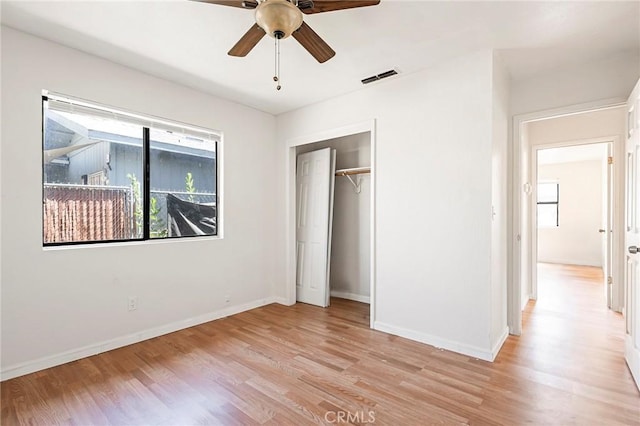 unfurnished bedroom with ceiling fan, a closet, and light hardwood / wood-style floors