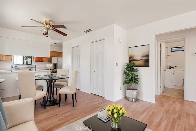 living room featuring ceiling fan and light hardwood / wood-style flooring