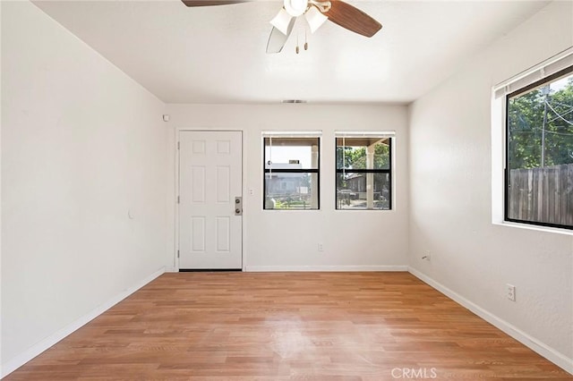 empty room featuring ceiling fan and light hardwood / wood-style flooring