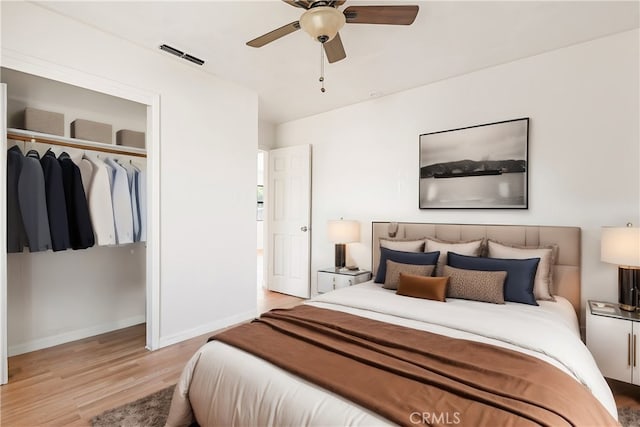 bedroom featuring ceiling fan, light wood-type flooring, and a closet