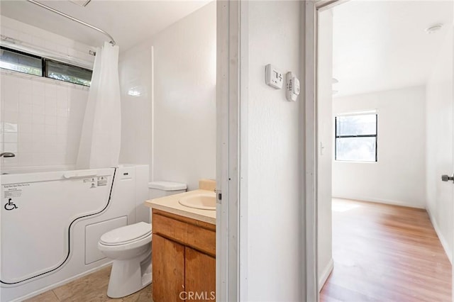 bathroom featuring a shower with curtain, vanity, hardwood / wood-style flooring, and toilet