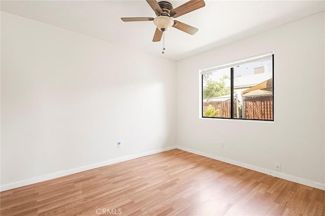 spare room featuring ceiling fan and light hardwood / wood-style flooring