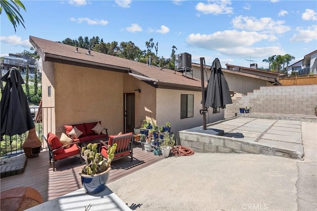 back of house featuring outdoor lounge area, cooling unit, stucco siding, a patio area, and fence