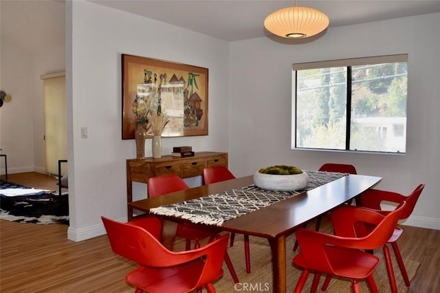 dining room with baseboards and wood finished floors