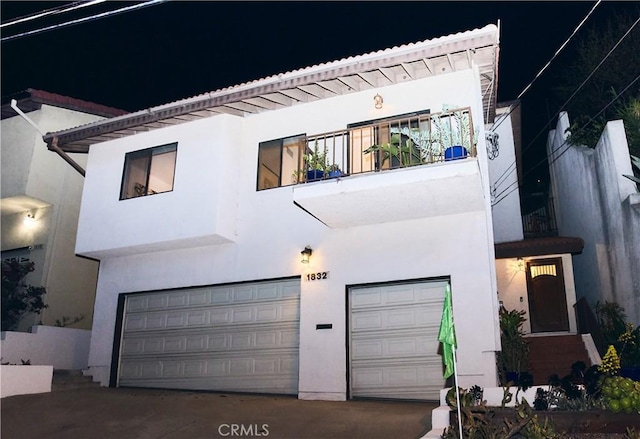 view of front facade with a balcony and a garage