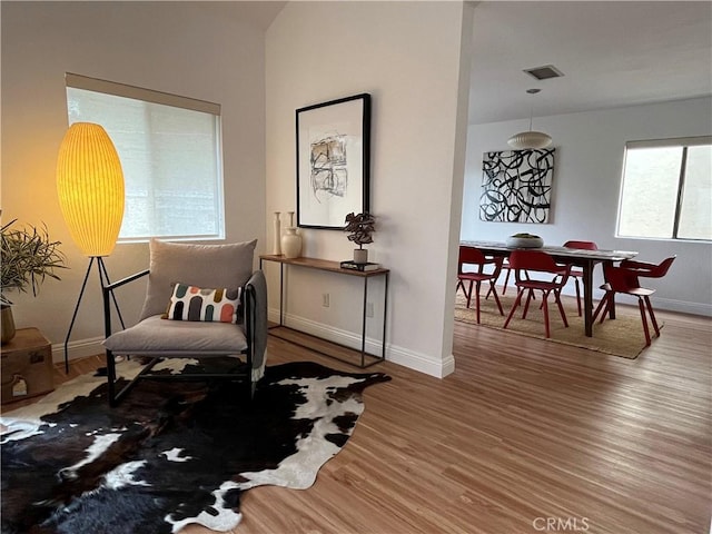 sitting room featuring baseboards and wood finished floors