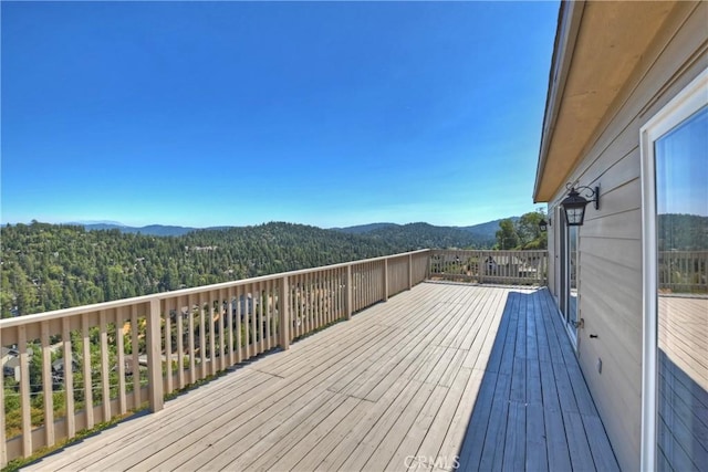 wooden deck featuring a mountain view