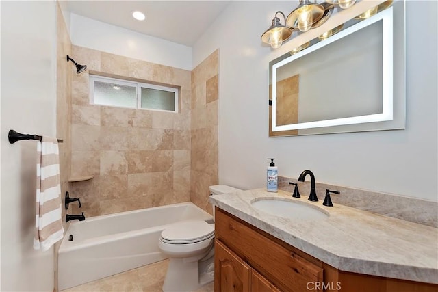 full bathroom featuring tile patterned floors, vanity, tiled shower / bath combo, and toilet