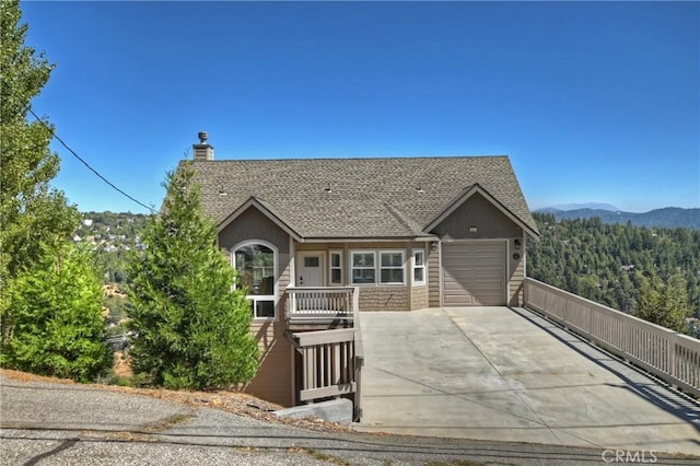 view of front of property with a mountain view and a garage