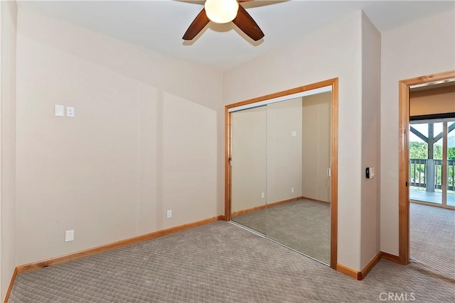 unfurnished bedroom with ceiling fan, light colored carpet, and a closet