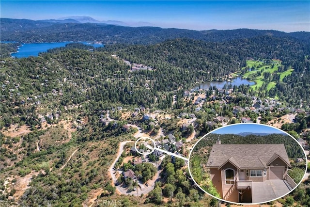 aerial view featuring a water and mountain view