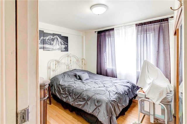 bedroom with hardwood / wood-style flooring