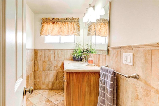 bathroom with tile walls, plenty of natural light, and vanity