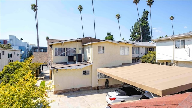 rear view of property featuring central air condition unit