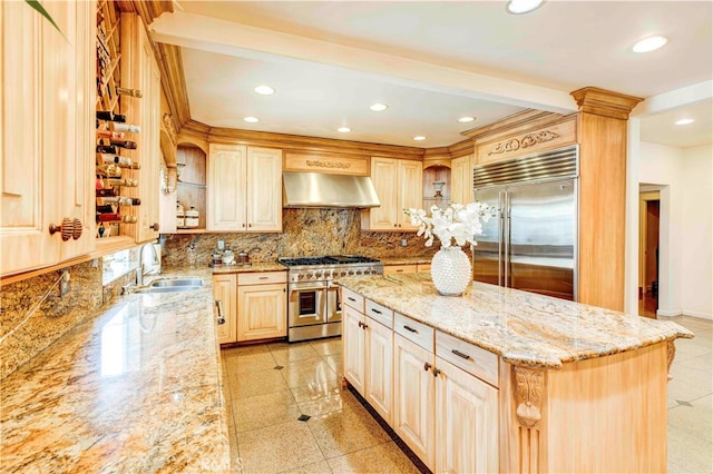 kitchen featuring a center island, sink, high end appliances, exhaust hood, and light stone countertops